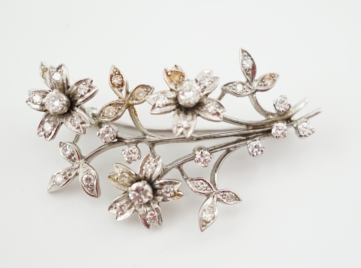 A 1960's 18ct white gold and diamond cluster set floral spray brooch